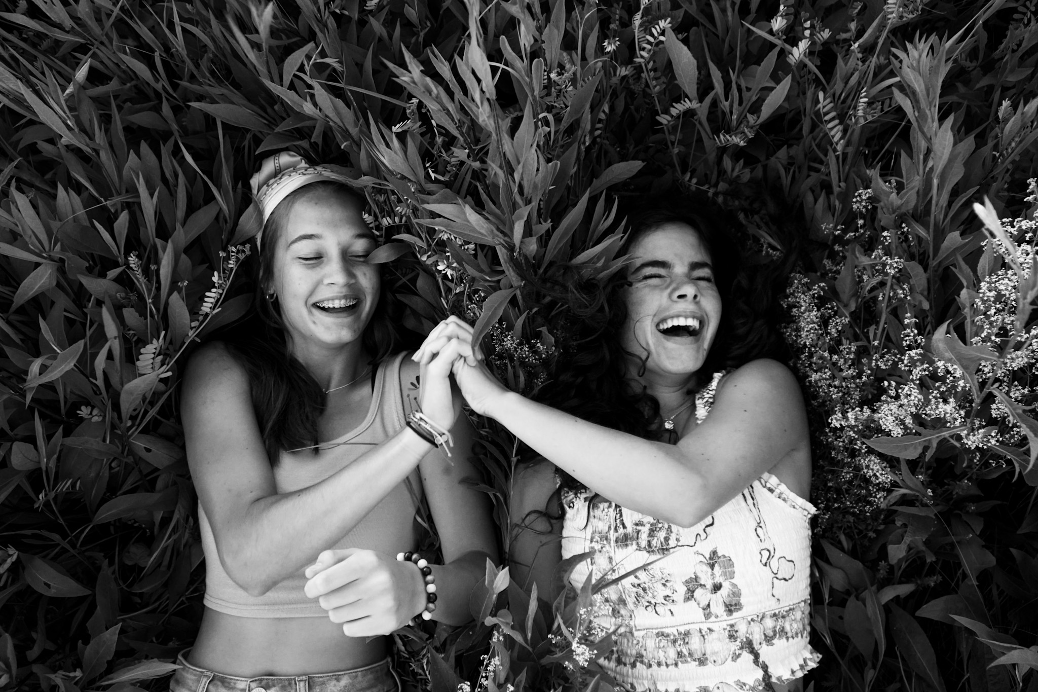 Two friends laughing, black and white